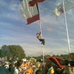 Kid climbs flagpole in Other Stage Arena.