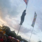Man climbs flag
