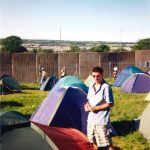 I had a ticket that year (one of the few) and I couldn't find any space to camp on site because too many people had busted in. I was not happy. haha. Not me in the pic, a mate. That is the outside of the fence in the background. We found mates and ended up camping in the NME Stage field. Bit better than where we were in this pic. Amazing weekend!