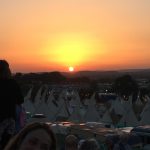 Sunset on hill by tipi fields